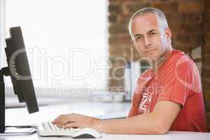 Businessman in office typing on computer
