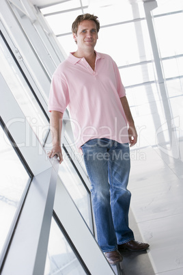 Man standing in corridor smiling