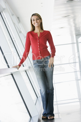 Woman standing in corridor smiling