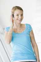 Woman standing in corridor wearing headset and smiling