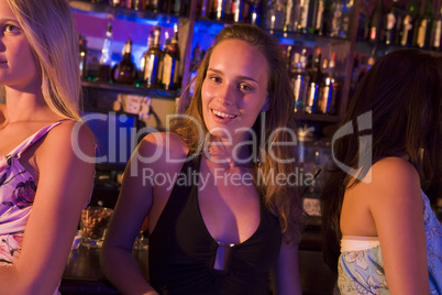 junge blonde Frau sitzt in einer Bar