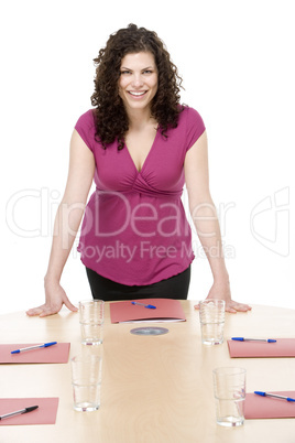 Businesswoman standing in boardroom smiling