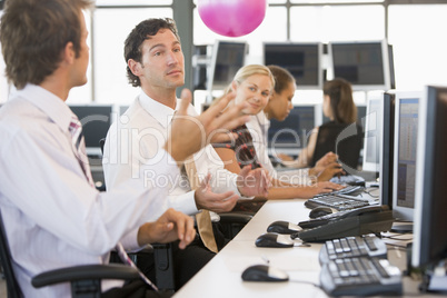 Five businesspeople in office space with a ball being thrown