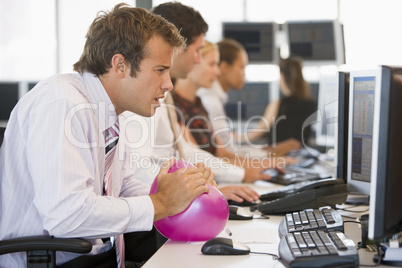 Businessman in office space with a ball