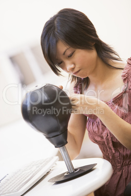 Woman in computer room sitting by small punching bag