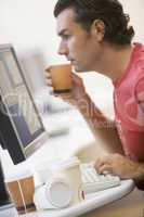 Man in computer room with many empty cups of coffee