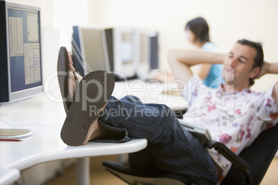 Man in computer room with feet up relaxing