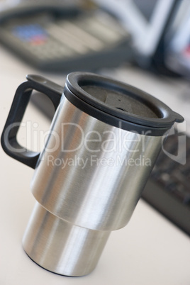 Shot of a reusable coffee cup on a desk