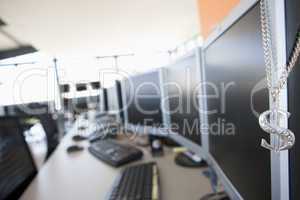 Shot of a necklace hanging on a monitor in a computer room