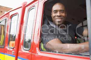 Ein Feuerwehrmann sieht aus dem offenen Fenster eines Feuerwehrfahrzeuges heraus