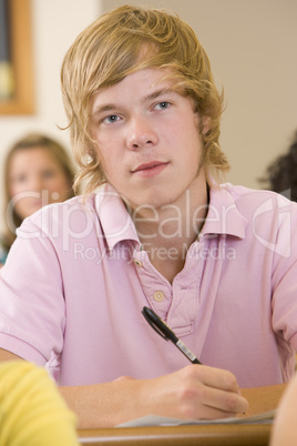 Male college student listening to a university lecture