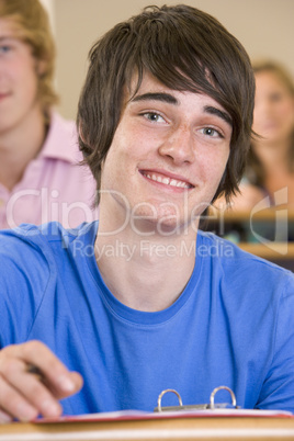 Male college student listening to a university lecture