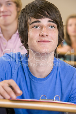 Male college student listening to a university lecture