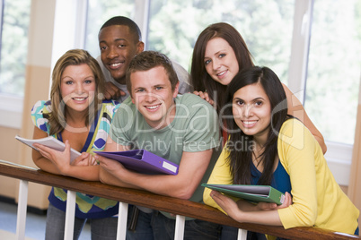 Group of college students leaning on banister