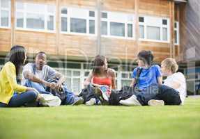 College students sitting and talking on campus lawn