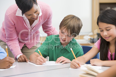 Elementary school teacher helping pupil