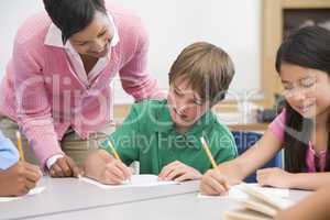 Elementary school teacher helping pupil