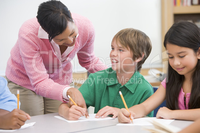 Teacher and pupil in elementary school classroom