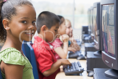 Kindergarten children learning how to use computers.