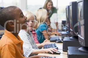 Kindergarten children learning how to use computers.