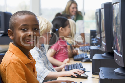 Kindergarten children learning how to use computers.