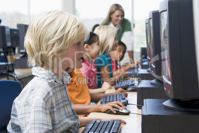 Kindergarten children learning how to use computers.