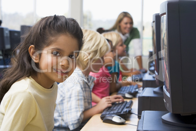 Kindergarten children learning how to use computers.