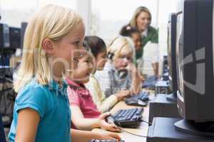 Kindergarten children learning how to use computers.