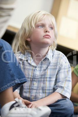 Boy daydreaming at kindergarten