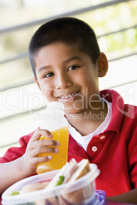 Boy eating lunch at kindergarten