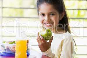 Girl eating lunch at kindergarten