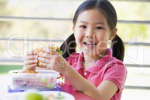 Girl eating lunch at kindergarten