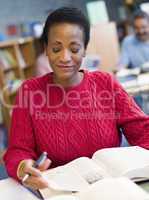 Mature female student studying in library