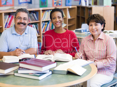 Mature students studying in library