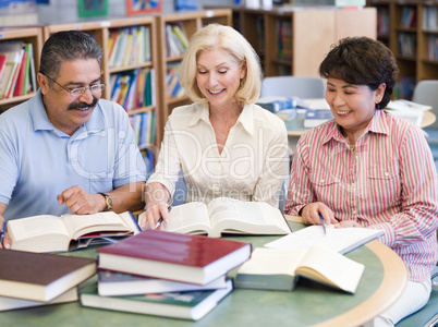 Mature students studying in library