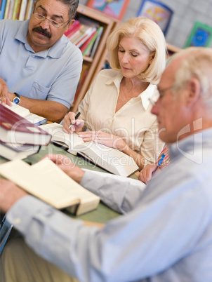 Mature students studying in library