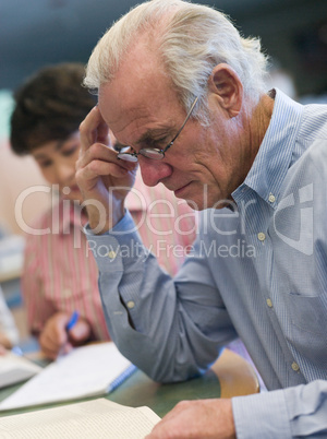 Mature male student studying in library