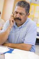 Mature male student frowning in class