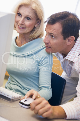 Mature female student learning computer skills