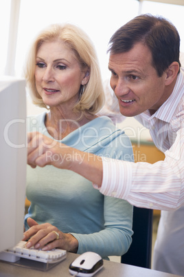 Mature female student learning computer skills