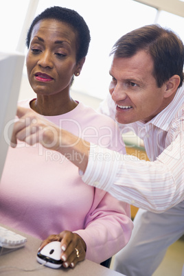 Mature female student learning computer skills