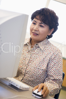 Mature female student learning computer skills