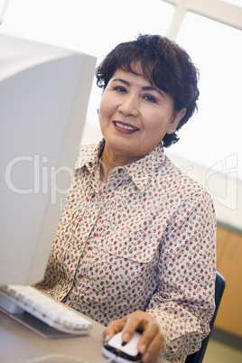 Mature female student learning computer skills