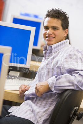 Schoolboy sitting in front of a computer in a high school class