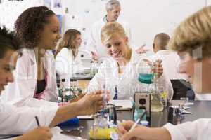 School children and their teacher in a high school science class