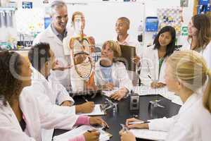 School children and their teacher in a high school science class