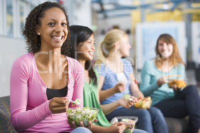 Teenage girls enjoying healthy lunches together