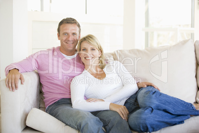 Couple relaxing in living room and smiling