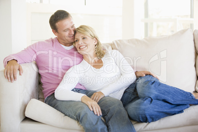 Couple relaxing in living room and smiling