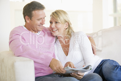 Couple relaxing with a magazine and smiling